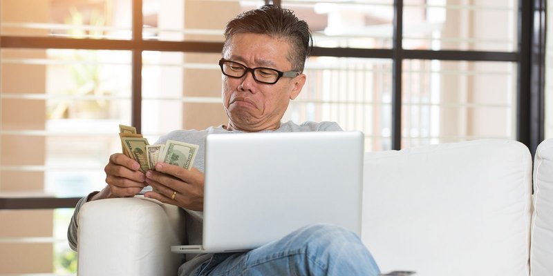 man-cash-laptop-sofa-HEADER-shutterstock_399137.original